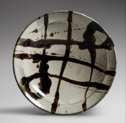Very large shallow bowl with nuka (rice-husk) white glaze ground with ladle-poured iron-glazed black trailing design