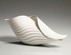 Horizontal ribbed, curled leaf-shaped sculptural vessel with undulating open mouth and creamy white-matte glaze, 2018