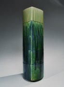 SUZUKI TETSU (b. 1964), Gradated green-glazed tall almond-shaped vessel with four concentric carved bands