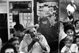 Cuba, Man with a hat lighting a cigarette, January, 1963