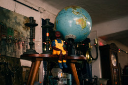 A detail of an antiques collection on the way to one of the homes she works for, featuring an Afro-descendant doll with the world on her back - it seemed to me like a metaphor for Ana Maria Jeremias&#039; life. Lisbon, Portugal, 2024