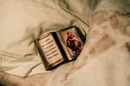 A detail of Ana Maria Jeremias&#039; bedroom, showing St. Anthony, the patron saint of Lisbon. Revered for his role in the Catholic faith, St. Anthony is also deeply linked to Portuguese colonialism, particularly in Brazil, where he became a symbol of both religious devotion and colonial authority. As a popular figure among Portuguese settlers, his image was often venerated in Brazil, where his association with the colonizing mission reinforced the ties between the metropolis and its colonies, shaping both cultural and religious practices in the region. Lisbon, Portugal, 2024