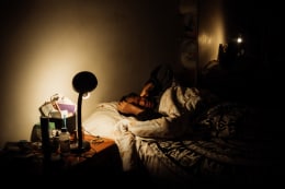 Ana Maria Jeremias at home, falling asleep as soon as she arrives, sleeping only about 4 hours per day. Lisbon, Portugal, 2024