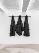 Wade Nobile, Rain Curtain, 2020, PVC raincoats, grommets, latex, and galvanized steel, 61 x 63 1/2 x 8 3/4 in (154.9 x 161.3 x 22.2 cm)