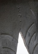 Laura Johnson Drake's metal and wood chair, detailed view of signature on legs