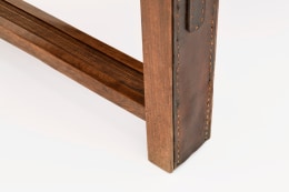 Jacques Adnet's coffee table/bench detailed view of leather and wood of leg