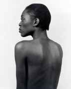 Nude portrait of a black woman in profile, back up.