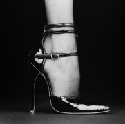 One foot in a high-heeled shoe and tights.