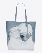 Purse with a photograph of two men wrapped together in white gauze.