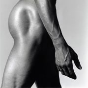 Nude black man from the side.