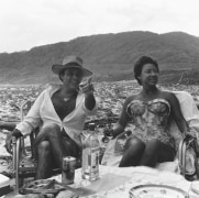 Princess Margaret and a man looking towards the right, on a beach.