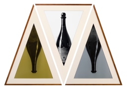 Geometric triptych of champagne bottles in triangular frames.