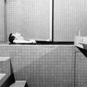 James Ford in profile, lying in bathtub.