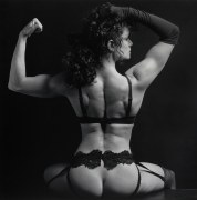 Lisa Lyon with back toward camera, wearing lingerie.