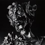 Portrait of satyr sculpture in 3/4 view.