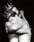 Two shirtless white men dancing, wearing crowns.