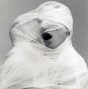 Two people wrapped together in white gauze.