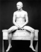 Portrait of Robert Sherman sitting on wooden bench.
