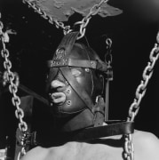 Man in leather mask with chains.