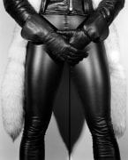 Person wearing leather outfit, gloves, and fur, from the waist to below the knee.
