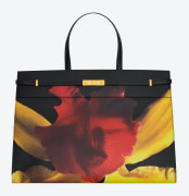 Purse with a photograph of a red and yellow orchid against a black background.