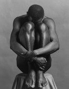 Ajitto sitting on pedestal, head facing into knees.