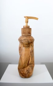 A soap dispenser, scaled up and hand carved out of wood.