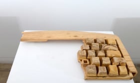 A broken keyboard, scaled up and hand carved out of wood.