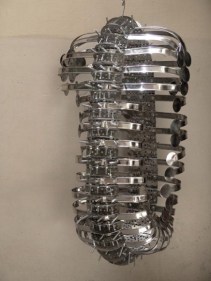 Adeela Suleman CAPSULE 2008 Steel drain covers, steel tongs, nuts and bolts 34.5 x 14.5 x 12 in.