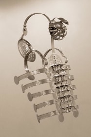 Adeela Suleman, Case 5, 2008, Steel drain covers, tongs, nuts and bolts, measuring and frying spoons, 34 x 14 x 11 in