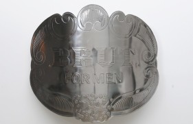 Abdullah M. I. Syed Brut for Men (English version) Hand-beaten metal medallion, wood and stainless steel 40 x 46 in. 2013