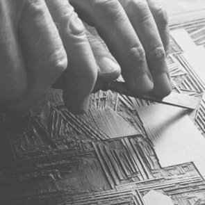 Lyonel Feininger carving a woodblock. 