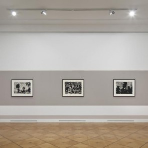 Three works by Mark Tobey hung on a gray wall.