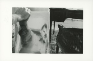A black and white photograph with a man in the mirror reflection