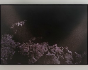 A photograph of a mountainous landscape in purple tones
