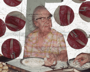 An image from a slide in Price's film. There is a granny with black glasses sitting at a table. Surrounding her are 6 circles that are excerpted images and depict red muscle.