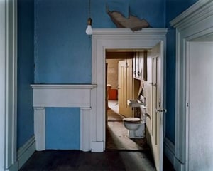 A photograph of a home interior with blue walls and white moulding and details