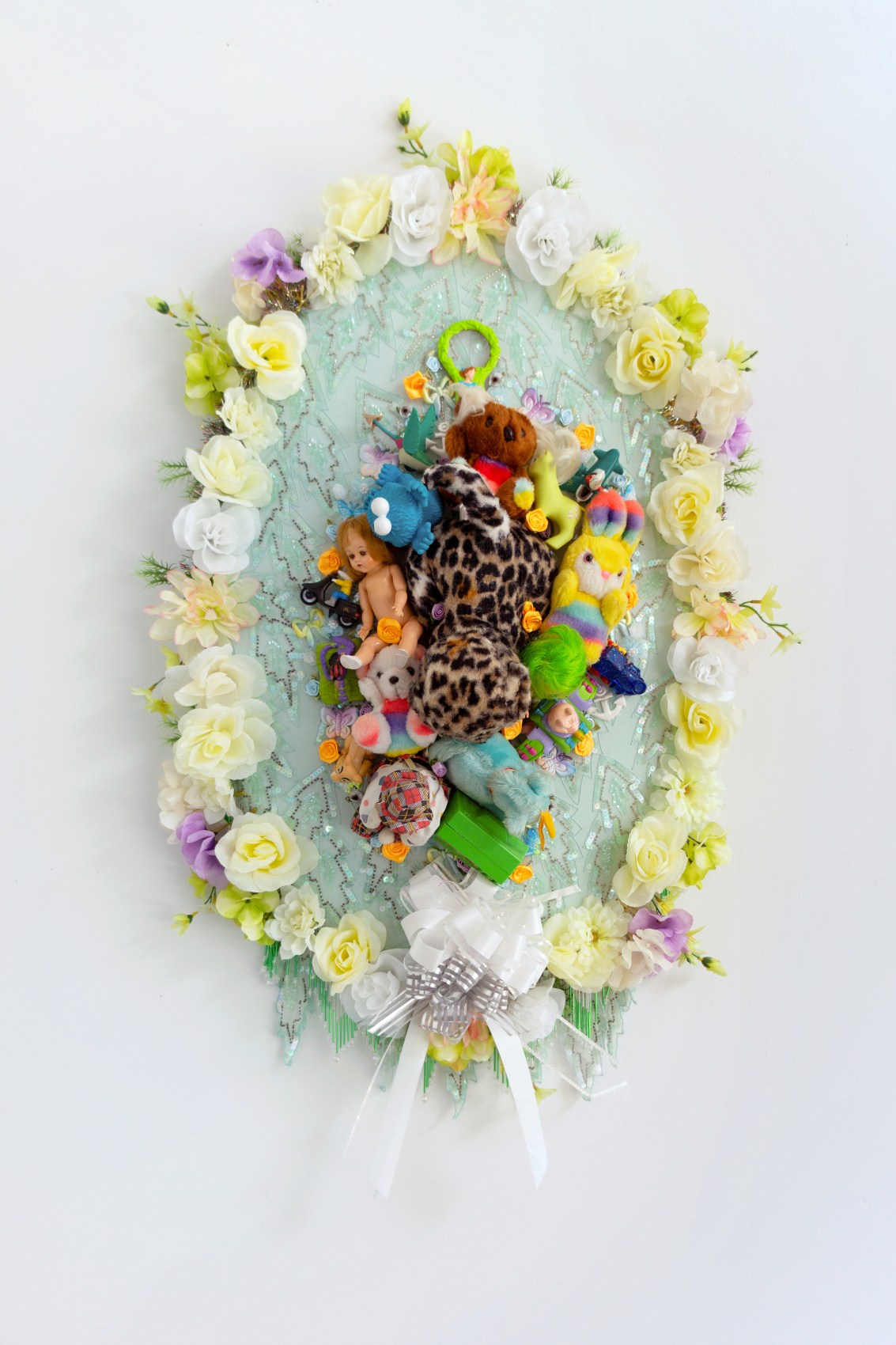 Max Colby,&nbsp;Elegy 15, 2020,&nbsp;Found fabric, trim, fabric flowers, ribbon, patches, toys, garland, polyester batting, Baltic birch plywood, thread,&nbsp;44 x 30 x 15 in (111.76 x 76.2 x 38.1 cm)