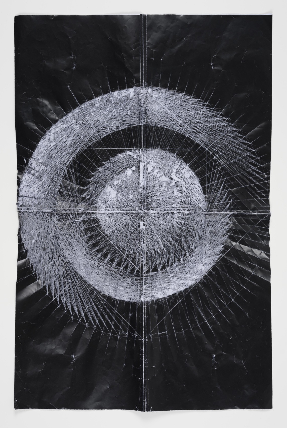 Abstract dark geometric shapes on folded paper with toner