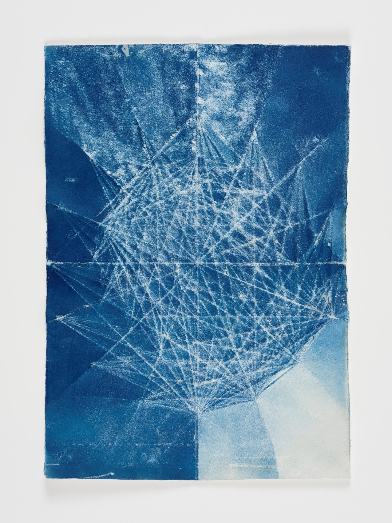 Abstract blue and white geometric shapes via cyanotype on folded paper