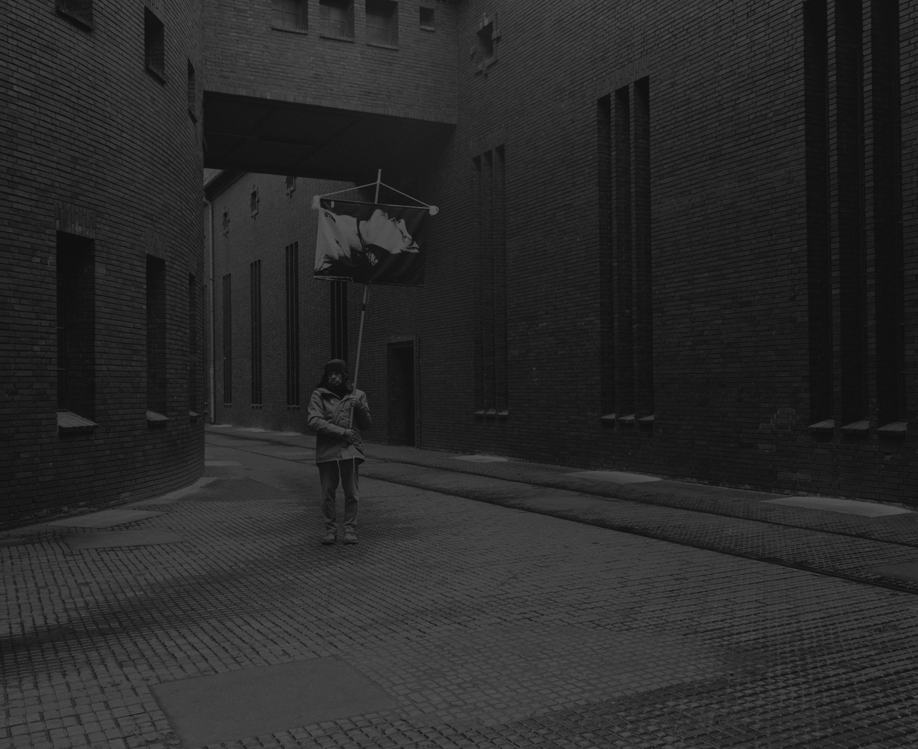 Daniel Joseph Martinez The Abspannwerk Humboldt (electrical power substation) in the Kopenhagener Straße is an extraordinary example, designed by the important industrial architect Hans H. Müller and built in 1927. The Wall was constructed directly next to the Abspannwerk Humboldt, so that it was in the East sector, and the Kopenhagener Straße was used as an entry point to the death strip by the border guards and their vehicles., 2017 Medium format black & white film printed digitally on Hahnemule Fine Art Baryta, Gloss 315gsm 60 x 72 in (152.4 x 182.88 cm)