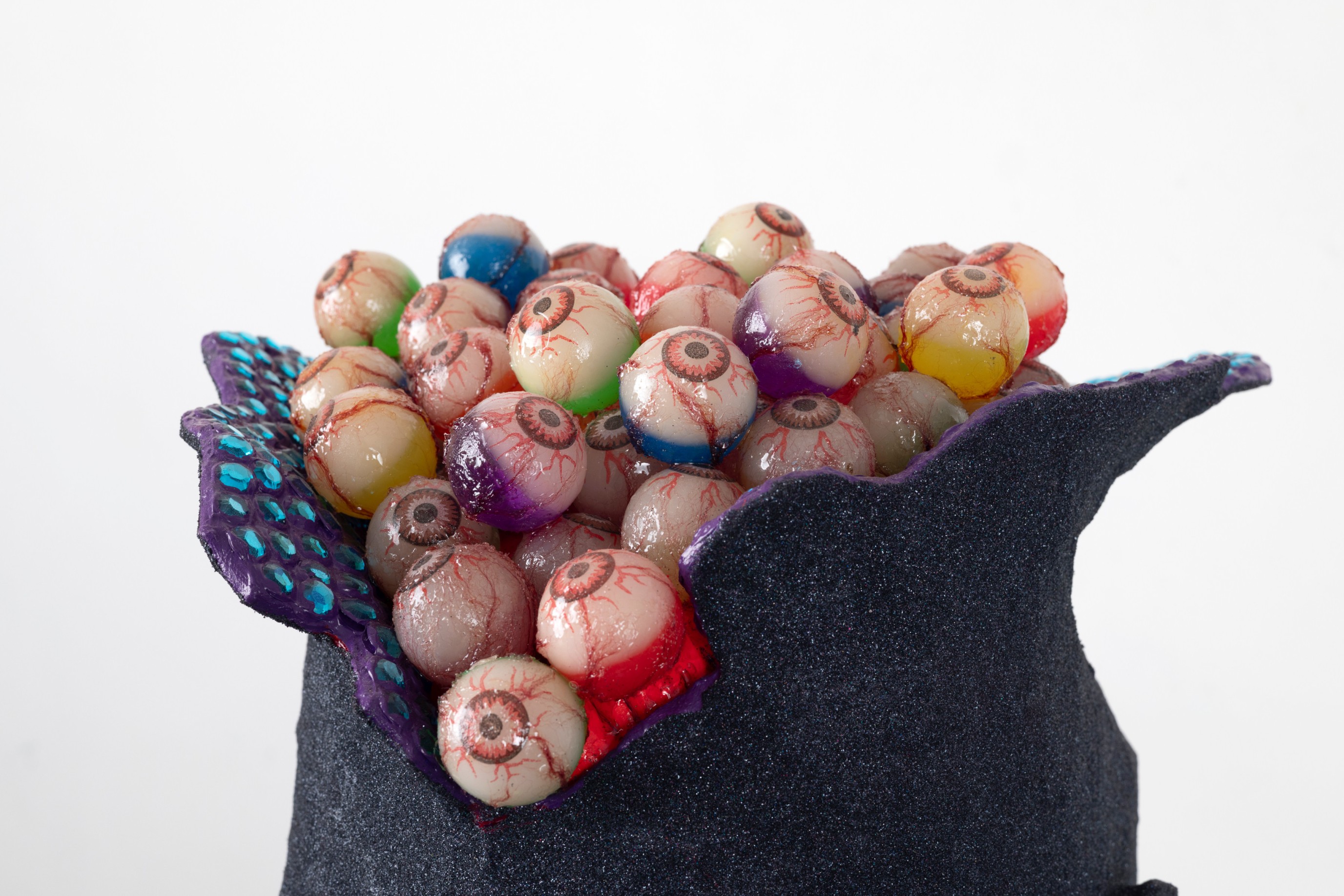 Arthur Pe&ntilde;a, Attempt 212 (detail), 2023, foam, acrylic, glitter, rhinestones, rubber eyeballs, thread, resin, 3-D printed door, chains, steel, drywall, pine, 24 x 24 x 55 inches, courtesy the artist and Harlesden High Street, London