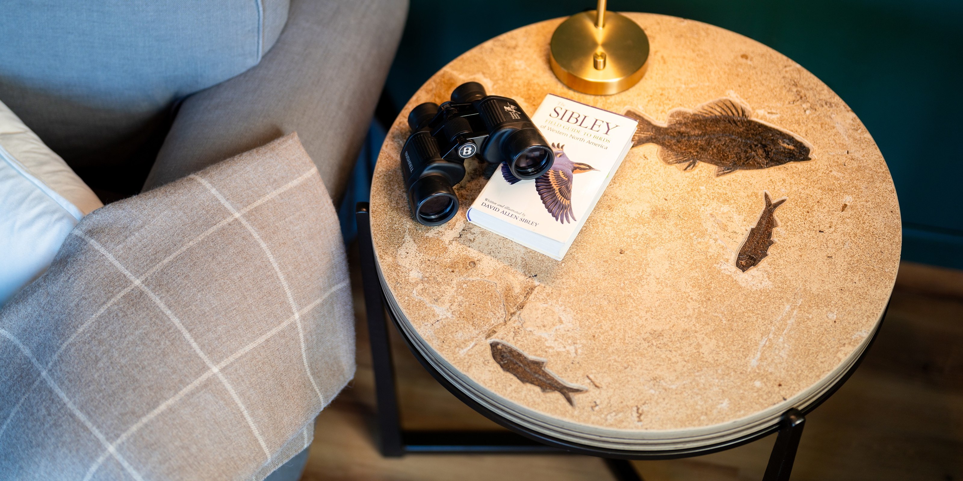 A top view of our 16&#039; round drink table. The stone is a brushed finished with the fossils in shallow relief. The base is made of hand-forged iron and steel.