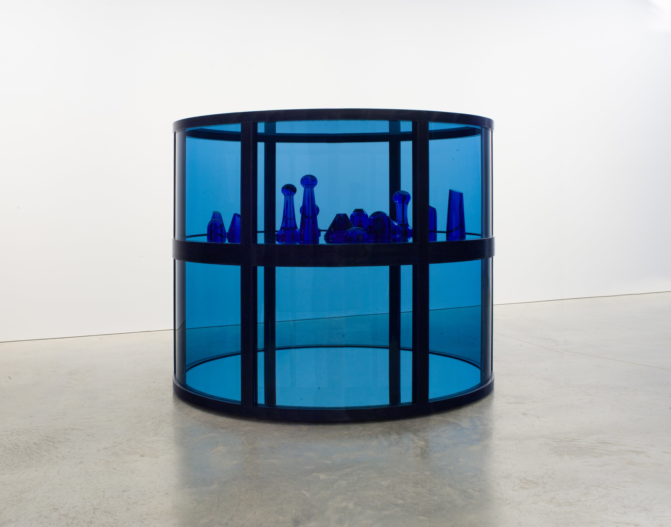 Cylindrical blue glass structure with blue glass sculptures inside