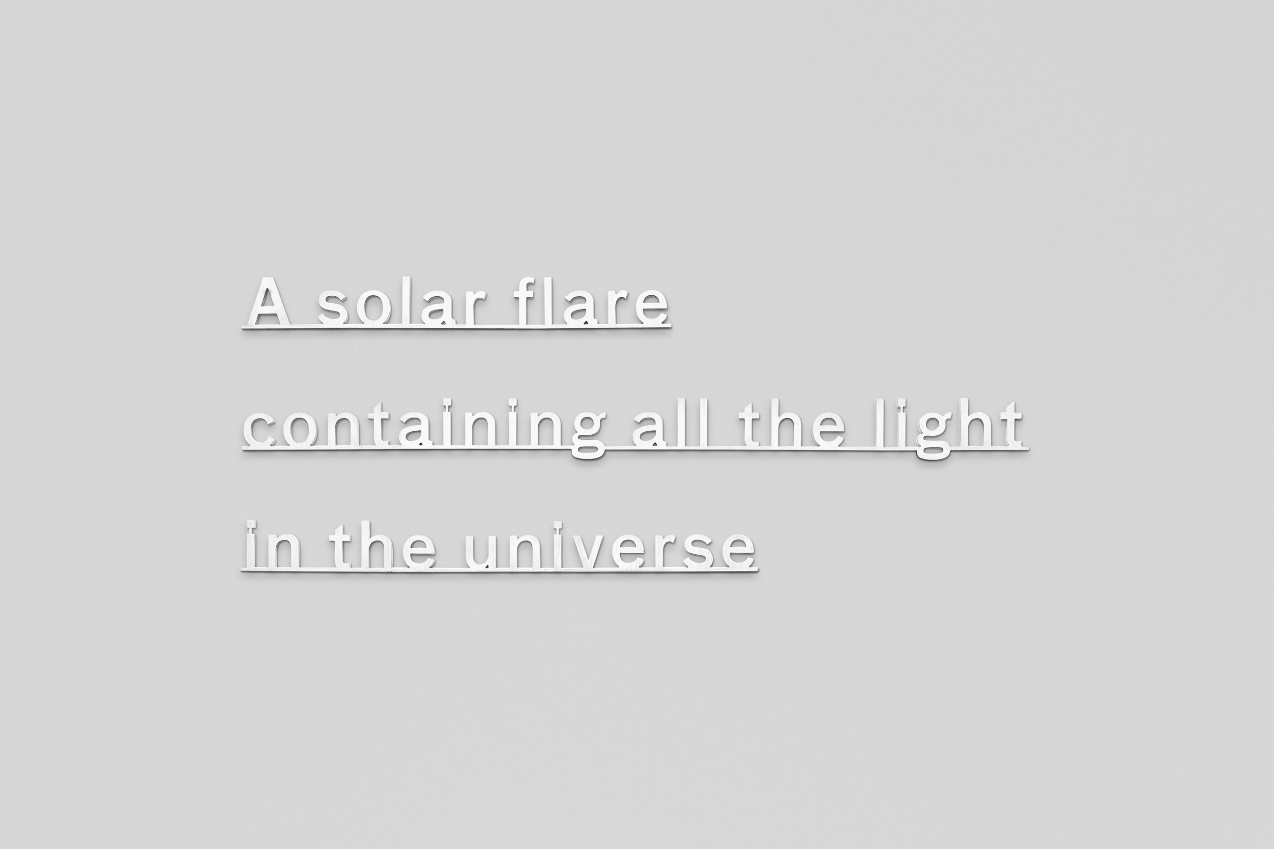 text made of Micro waterjet cut sterling silver attached to a white wall