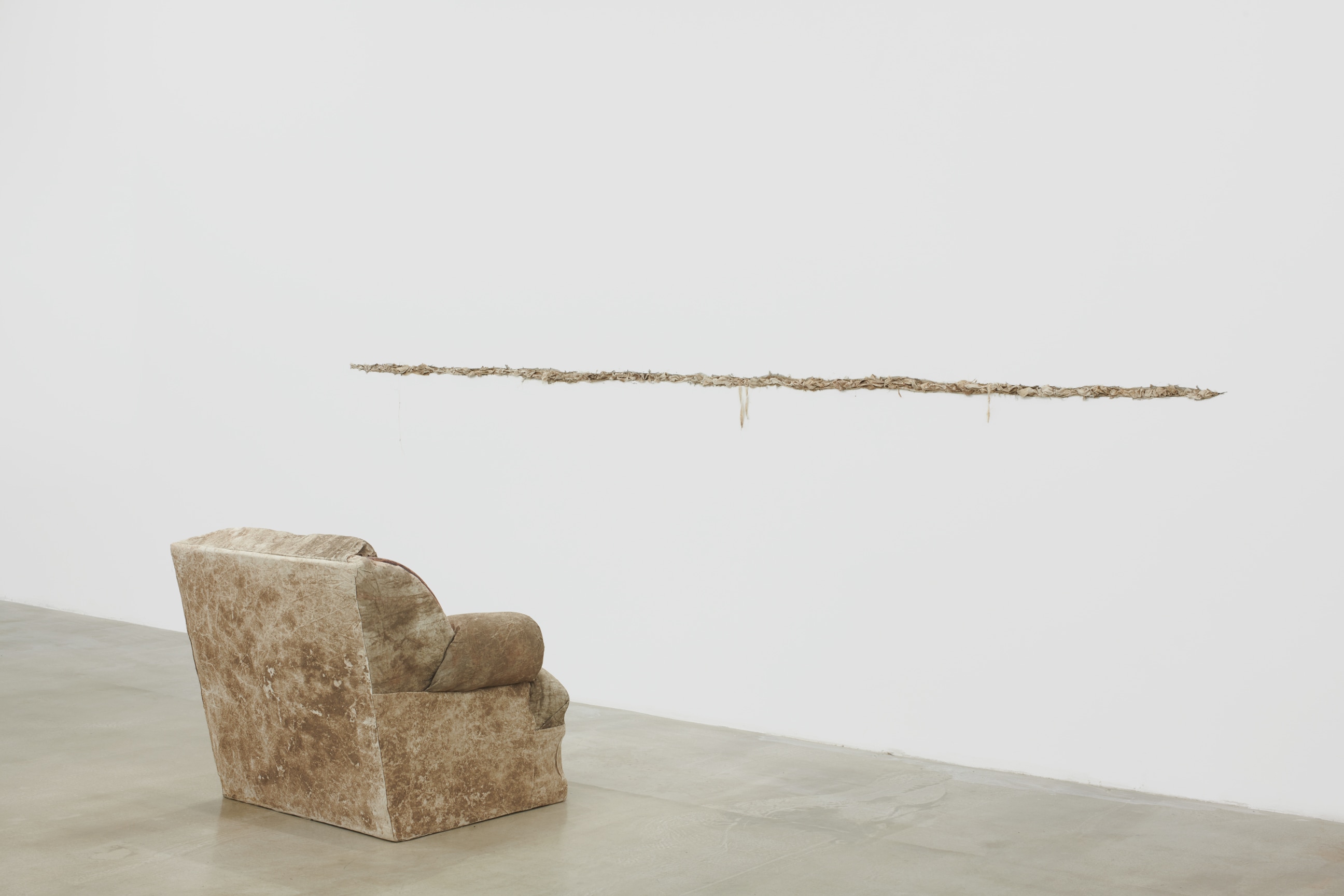 chair facing crack on the wall stuffed with cloth