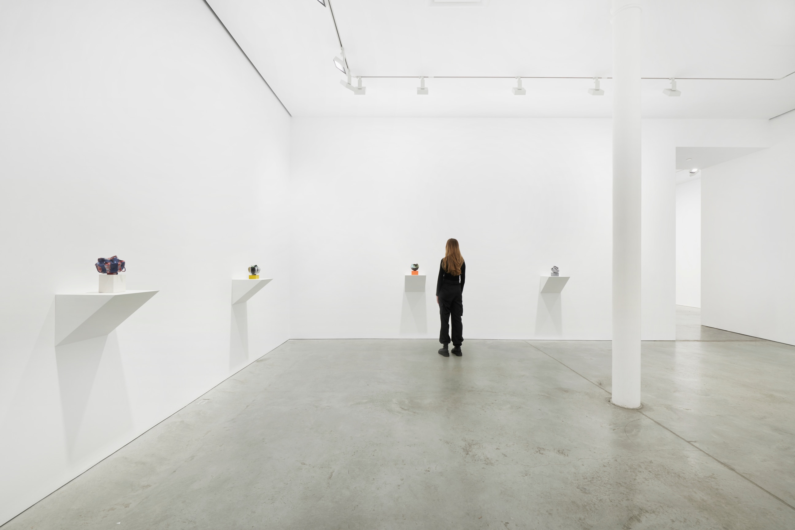 person looking at small artworks