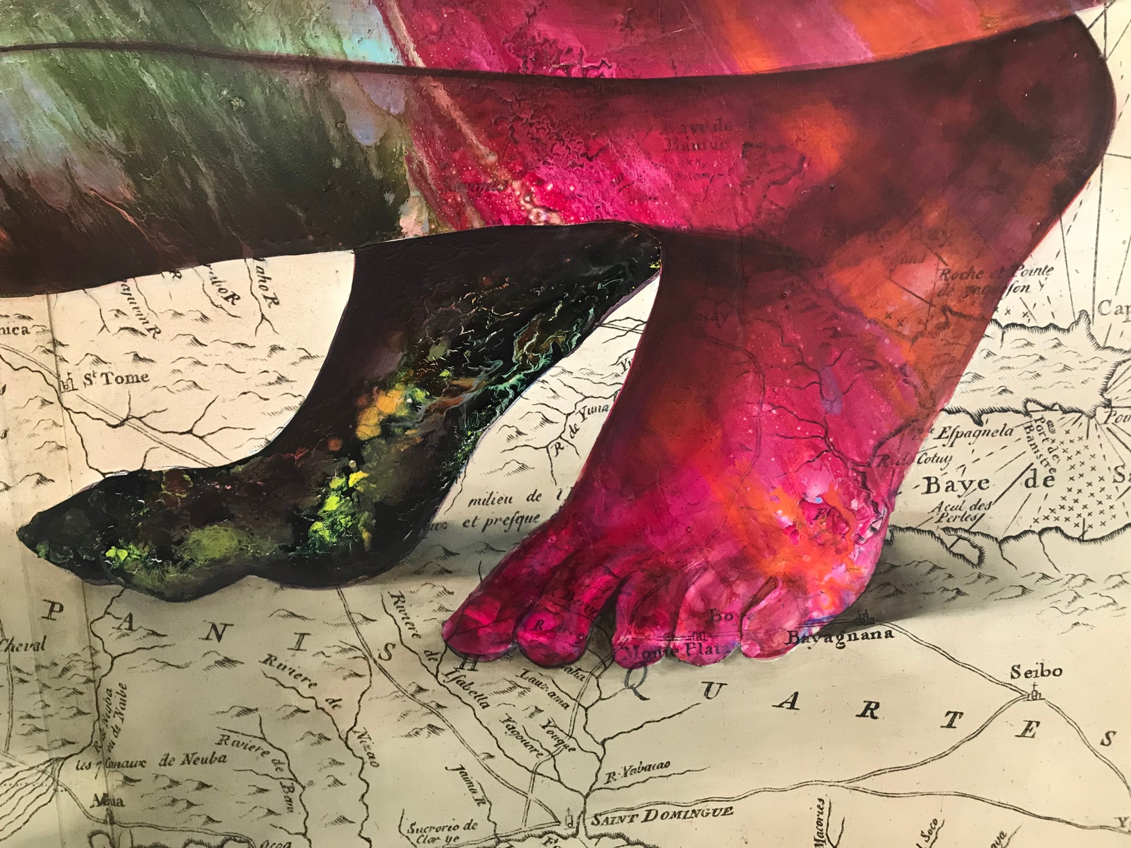 multicolored feet over a mpa of the Hispaniola