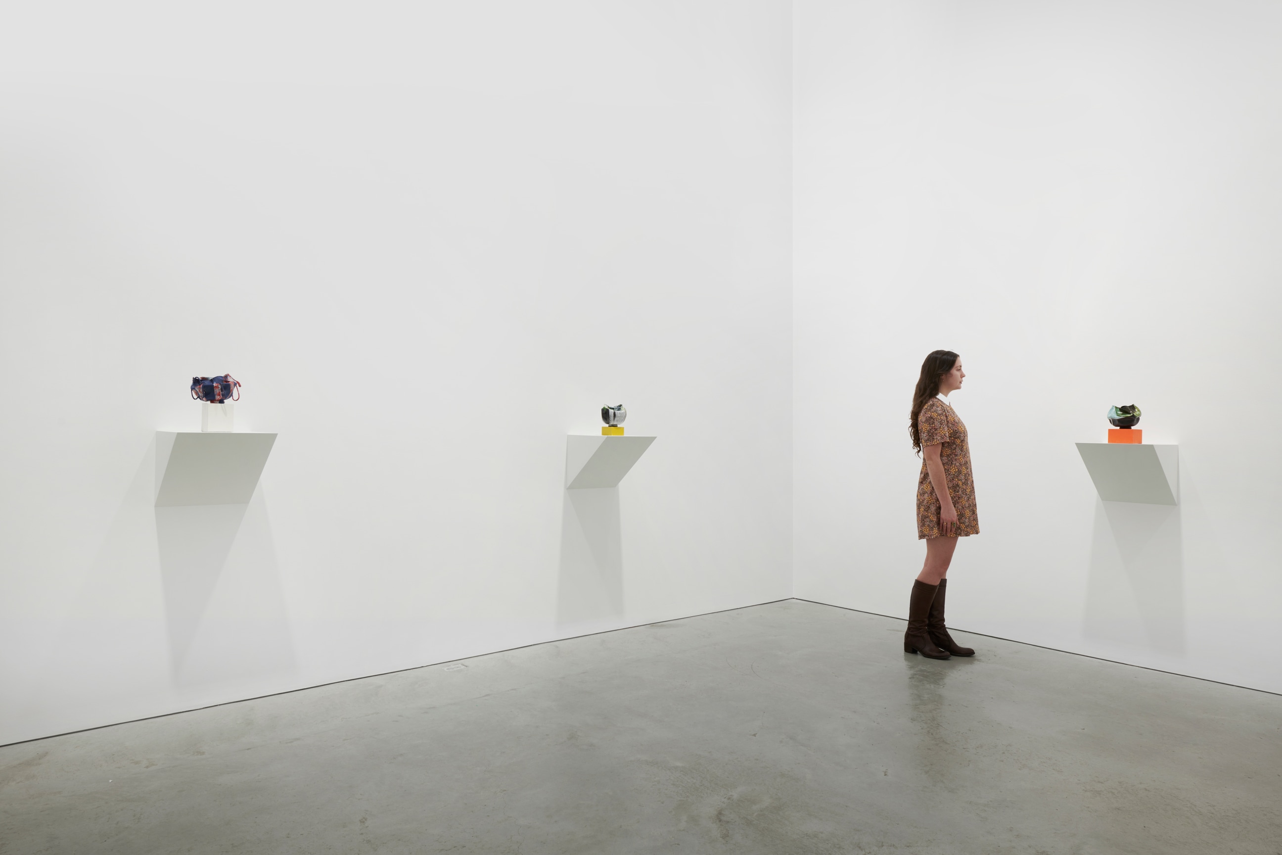 person looking at a small artwork