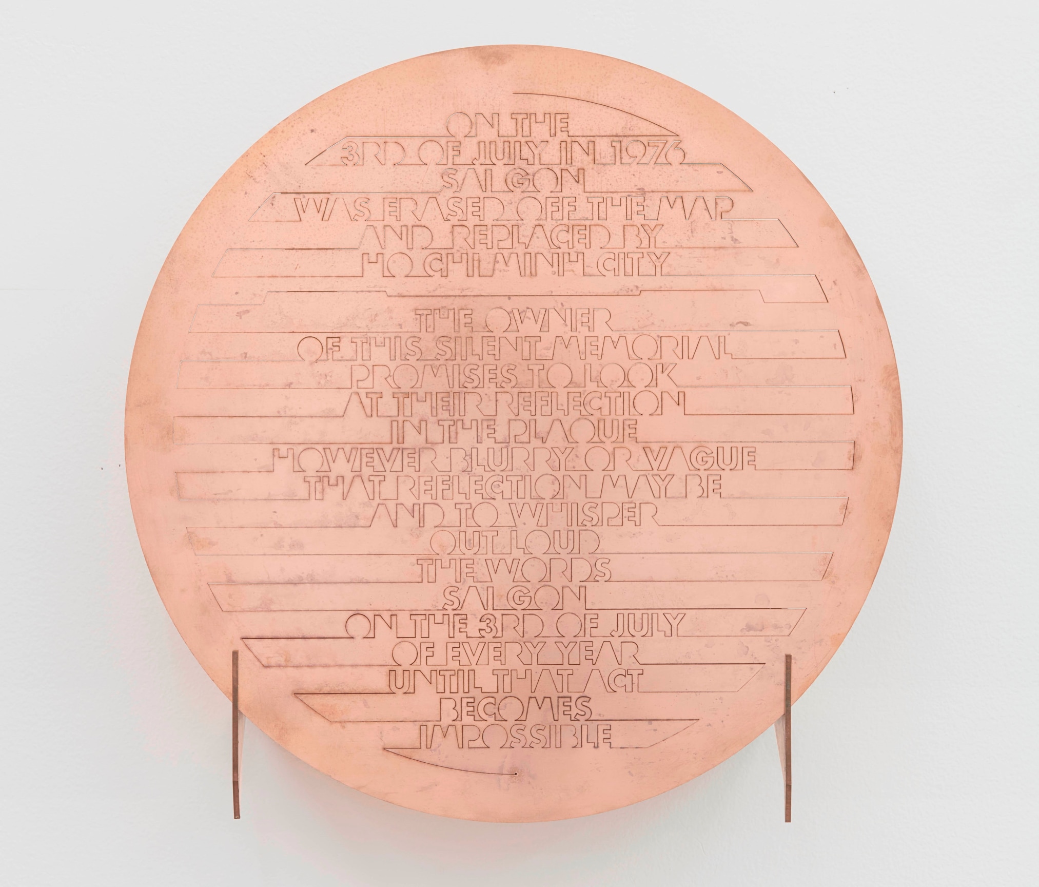 brass circle with text inscribed